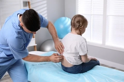Pediatric Chiropractor Near Me – Suffolk Physical Therapy & Chiropractic Child receiving gentle chiropractic care from a pediatric chiropractor at Suffolk Physical Therapy & Chiropractic on Long Island, NY