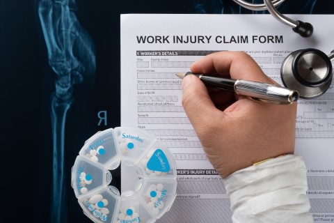 Picture of a person filling out a form to receive work injury treatment on Logn Island, NY