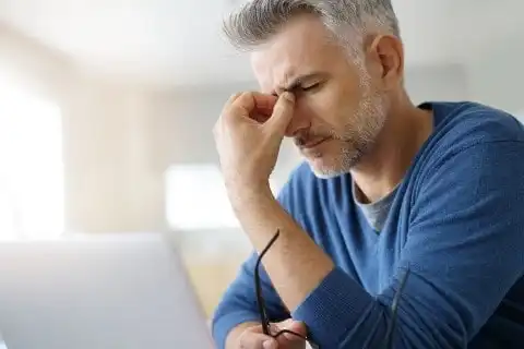 Headache and Neck Pain from Car Accident – Suffolk PT & Chiropractic Person experiencing headache and neck pain after a car accident, treated at Suffolk Physical Therapy & Chiropractic
