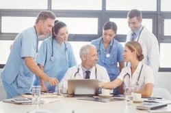 No-Fault Doctors in Suffolk County, NY Collaborating on Patient Care Team of no-fault doctors and medical staff in Suffolk County, NY discussing patient treatment plan